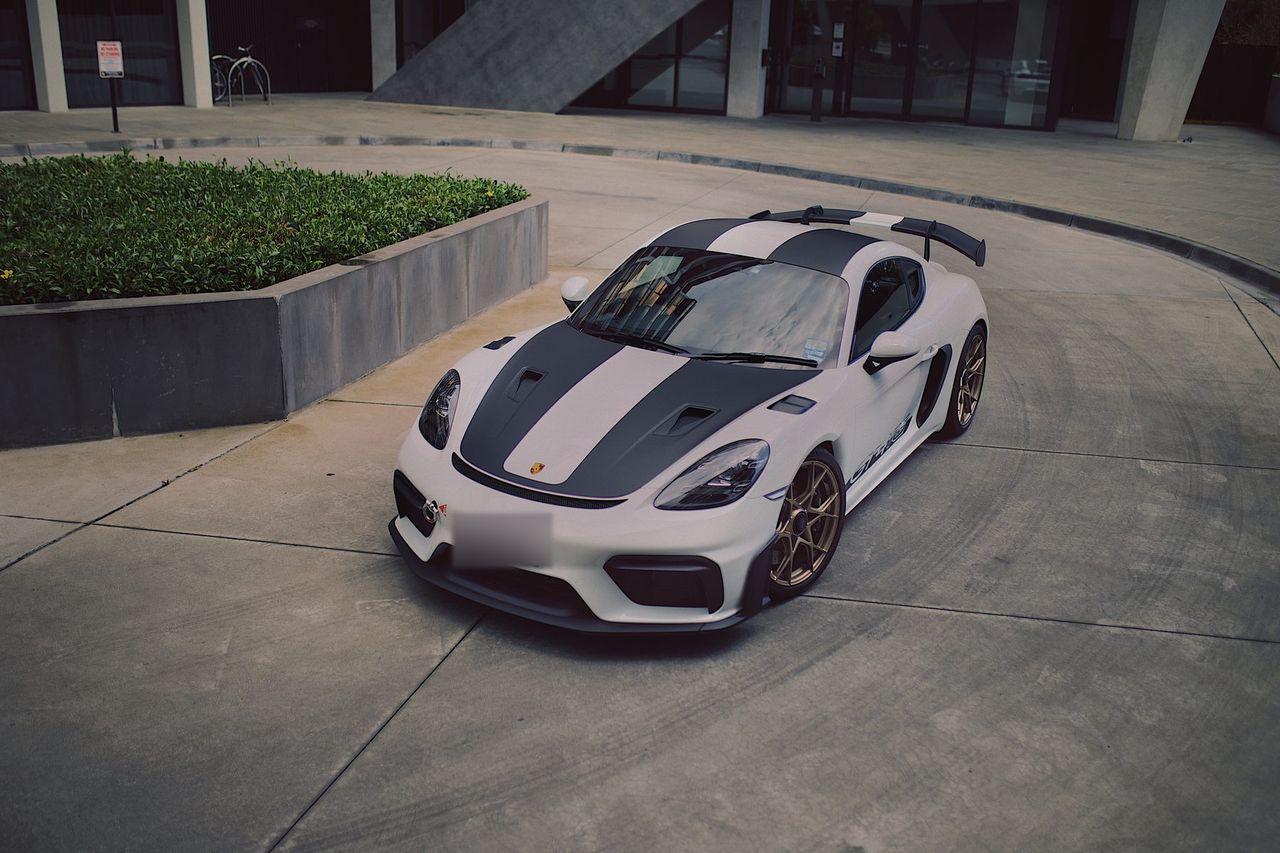 The white GT4 RS from above, showing the twin stripes over the bonnet and roof