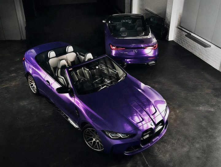 Purple BMW M4 Convertible and a purple Mercedes CLE Cabriolet, seen from above in a dark studio