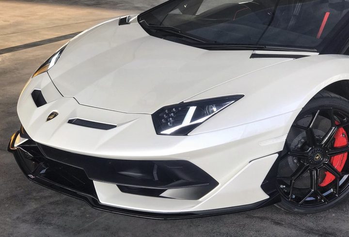 Front of a pearl white Lamborghini Aventador SVJ after paint protection film